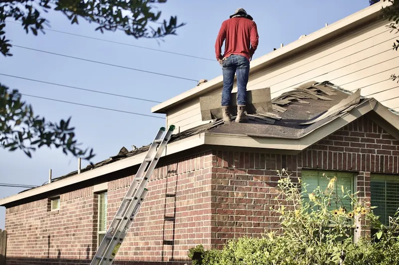 Professional roofer working on a residential roof in Buzzard Point